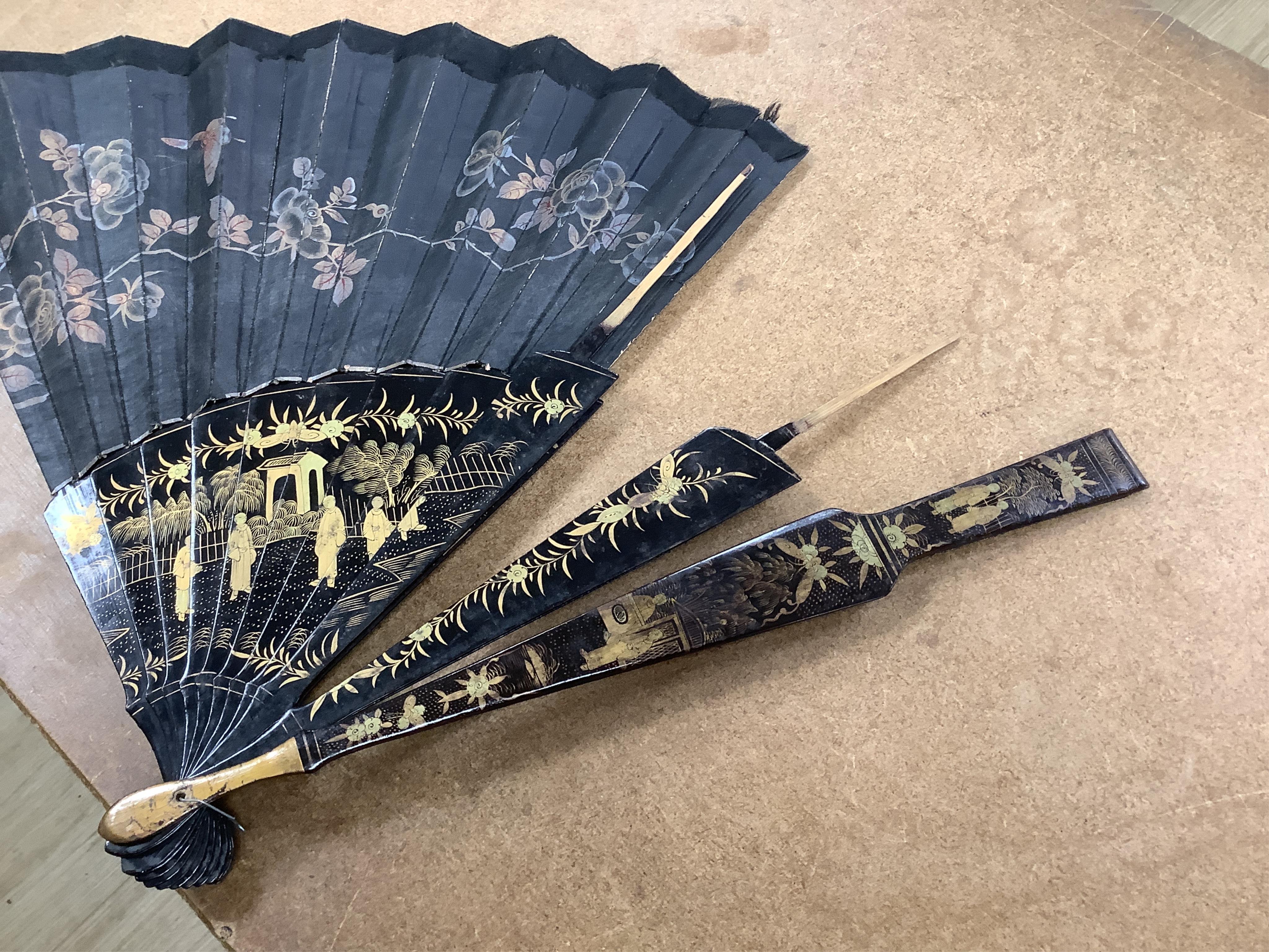 Four 19th century Chinese gilt-decorated black lacquer fans with figure painted leaves, two cased, largest 41cm
